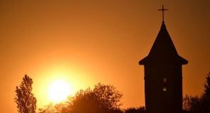 Silhouette of Christian Church with sunset in background